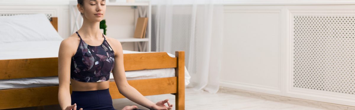 Donna pratica meditazione mattutina in camera da letto